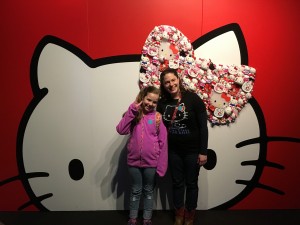 Rachael and Gigi pose in front of a giant Hello Kitty head at the EMP exhibit.